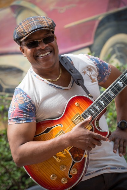 A musician man holding a guitar