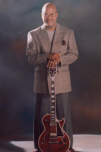 A musician man holding a guitar